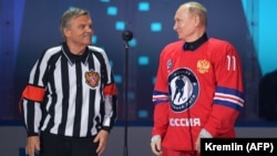 IIHF President Rene Fasel (left) and Russian President Vladimir Putin attend the opening ceremony of the Night Hockey League gala match at the Bolshoi Ice Dome in Sochi, Russia, in May 2021.