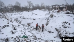 Rescuers with a dog work at the site of a Russian missile strike in the town of Pokrovsk, in Ukraine's Donetsk region, on January 8.
