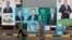 People walk past electoral campaign posters ahead of Iraq's parliamentary elections in central Baghdad on November 6.