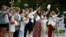 Women hold flowers during a demonstration in Minsk on August 20 against violence following recent protests to reject the presidential election results.