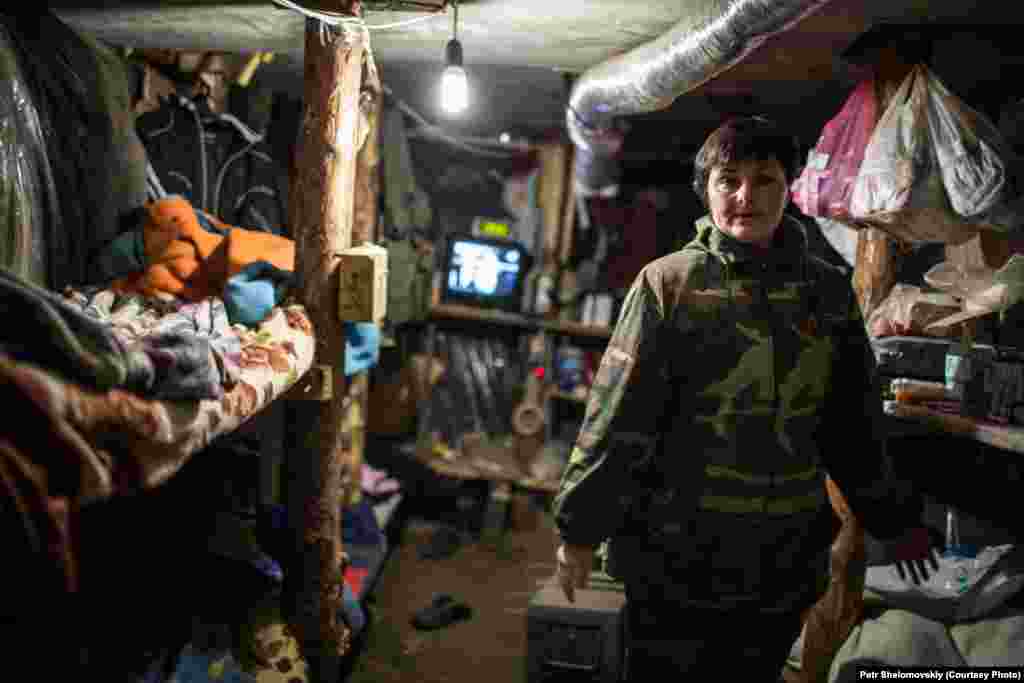 Tatiana, a nurse assisting pro-separatist fighters, inside a dugout at a rebel checkpoint in Gorlovka. 