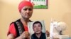 KAZAKHSTAN-CHINA-RIGHTS-XINJIANG-COURT Bikamal Kaken poses with a portrait of her disappeared husband Adilgazy Muqai in a rental apartment in the provincial town of Uzynagash, around 60 kilometres from Kazakhstan’s largest city Almaty, on August 27, 2020.