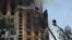 Rescue crews work to extinguish a fire in a residential building following a missile attack in Kharkiv on August 30.