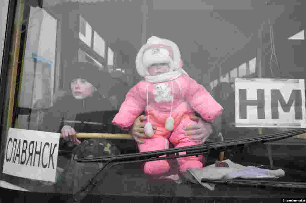 Debaltsevo township, Donetsk region, Ukrain. The territory is under ukranian control. The center of distribution of humanitarian aid in a former city hall. The refugges in buses are going to move to Slavyansk, which is under Ukrainian control.