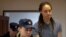 Brittney Griner is escorted after the final statements in a court hearing in Khimki outside Moscow in August.