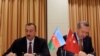 Azerbaijani President Ilham Aliyev (left) and Turkish Prime Minister Recep Tayyip Erdogan sign a protocol of the first meeting of Azerbaijan-Turkey High-Level Strategic Cooperation Council in Izmir on October 25.