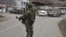 A Russian peacekeeper stands guard on a road in the town of Lachin in December 2020.