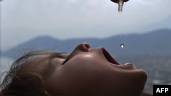 An Afghan health worker administers polio vaccine drops to a child in Afghanistan. (file photo)