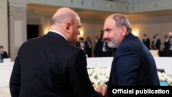 Kazakhstan -- Armenian Prime Minister Nikol Pashinian (R) greets his Russian counterpart Mikhail Mishustin at a Eurasian Economic Union meeting in Almaty, February 5, 2021.