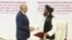 U.S. envoy Zalmay Khalilzad (left) and Mullah Abdul Ghani Baradar, the Taliban's top political leader, shake hands after signing a peace agreement in Doha on February 29.