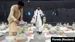 Men prepare free food donated by the Afghan government amid the spread of the coronavirus, in Jalalabad, Afghanistan, on April 28.