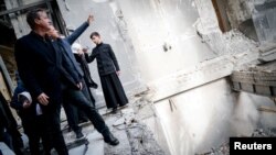 British Foreign Secretary David Cameron visits the Transfiguration Cathedral in Odesa, which was damaged by a Russian missile strike earlier this year, while visiting Ukraine on November 16. 