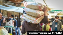 Базарда азык-түлүк ташып бараткан соодагер. Кыргызстан. (Иллюстрациялык сүрөт)