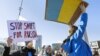 Demonstrators protest against Russia's full-scale invasion of Ukraine, in Geneva on February 26, 2022.