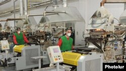 Armenia -- Workers at a car battery plant in Yerevan.