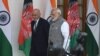 Indian Prime Minister Narendra Modi (right) and Afghan President Mohammad Ashraf Ghani walk together before a meeting in New Delhi on October 24.