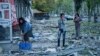 People clear the rubble in a front of a residential building that was heavily damaged after a Russian air strike in Kramatorsk in Ukraine's Donetsk region on September 25. 