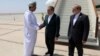 Iranian Foreign Minister Abbas Araqhchi (center) is welcomed by an unidentified Omani official upon his arrival in Muscat, Oman, for nuclear talks with the United States on May 11. 