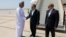 Iranian Foreign Minister Abbas Araqhchi (center) is welcomed by an unidentified Omani official upon his arrival in Muscat, Oman, for nuclear talks with the United States on May 11. 