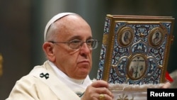 Vatican -- Pope Francis blesses the missal as he leads a mass on the 100th anniversary of the Armenian genocide in St. Peter's Basilica at the Vatican, April 12, 2015