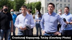 Dzmitry Baskau (right) "abused his position," the IIHF said, by trying to pressure players to back authoritarian ruler Alyaksandr Lukashenka.