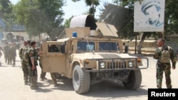 Afghan commando forces in Kunduz Province following clashes with Taliban insurgents on June 22. 