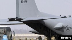 Kyrgyzstan -- US servicemen board a plane bound for Afghanistan at the US transit center at Manas airport, 07Mar2011