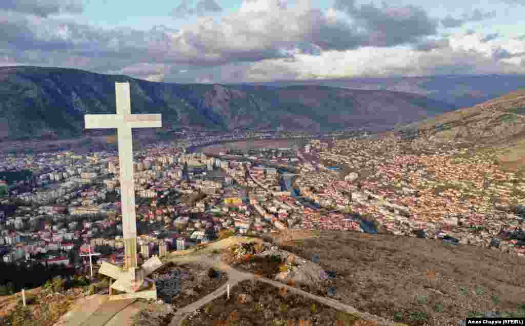A viewpoint above Mostar dominated by a 33-meter high cross. Since the end of the conflict in 1994, Mostar has been divided with Croats mostly living on the west side of the Neretva River (left side of photo) and Bosniaks to the east. &nbsp; &nbsp;
