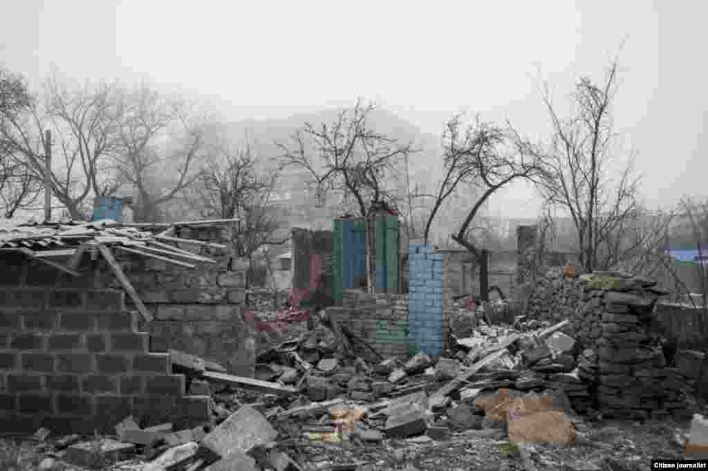 Debaltsevo township, Donetsk region, Ukrain. The territory is under ukranian control. The center of distribution of humanitarian aid in a former city hall. There is destroyed cottage in the center of the town.