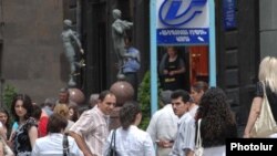 Armenia -- Bank employees anxiously wait outside their offices following an earthquake that struck Yerevan and surrounding areas on June 18, 2009.