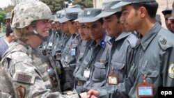 ABŞ hərbçisi təlimi başa vuran əfqan polis zabitləri ilə əl sıxır. 2008