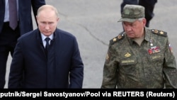 Russian President Vladimir Putin (left) and Defense Minister Sergei Shoigu visit the Mulino training ground to observe the military exercises Zapad-2021 staged by the armed forces of Russia and Belarus in Russia's Nizhny Novgorod region on September 13, 2021.
