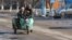 Люди едут на мотороллере. Село Сортобе, Жамбылская область. 2 февраля 2021 года.

