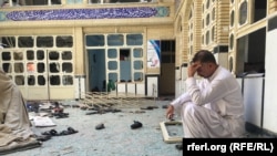 A man sits in a Herat mosque the day after a deadly attack that left at least 33 people dead. 