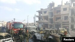 Syrian army soldiers inspect the site of a two bomb blasts in the government-controlled city of Homs, Syria, in this handout picture provided by SANA on February 21, 2016. REUTERS/SANA/Handout via Reuters ATTENTION EDITORS - THIS PICTURE WAS PROVIDED BY A