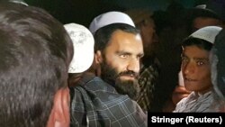 A newly freed Taliban prisoner hugs his relatives outside Bagram prison, north of Kabul, on April 8.