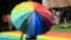 A person walks with a rainbow umbrella in the second Gay Pride parade in Skopje, North Macedonia, on June 26. 