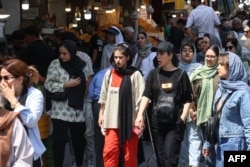 Iranian women walk in the Grand Bazaar in Tehran on August 13.