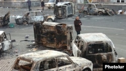 Armenia - A man walks past burned cars on a street in Yerevan where security forces clashed with opposition protesters, 2 March 2008.