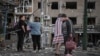 Residents observe the damage to an apartment building in Zaporizhzhya after a Russian air attack on August 30.
