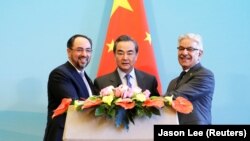 (Left to right:) Afghan Foreign Minister Salahuddin Rabbani, Chinese Foreign Minister Wang Yi and Pakistani Foreign Minister Khawaja Asif in Beijing on December 26. 