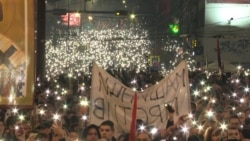 Protesters In Belgrade Light Up Night Sky During Moment Of Silence 