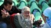 Bosnians mourn over the coffin of a relative during the preparation for a mass burial at the Srebrenica-Potocari Memorial and Cemetery in 2010.