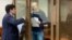 Russian opposition leader Vladimir Kara-Murza (right), talks to his lawyer Vadim Prokhorov during a preliminary court hearing in Moscow on March 6.