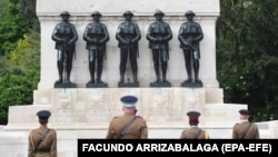British military officers observe two minutes of silence to commemorate Victory in Europe Day at the Guards memorial in London in 2020.