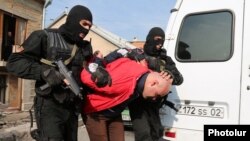 Armenia - Security forces detain a man in a raid on a house in Yerevan's Nork district, 25Nov2015.