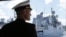 Российский военно-морской офицер возле военного корабля России «Адмирал Григорович» в Севастополе. 8 июля 2016 года