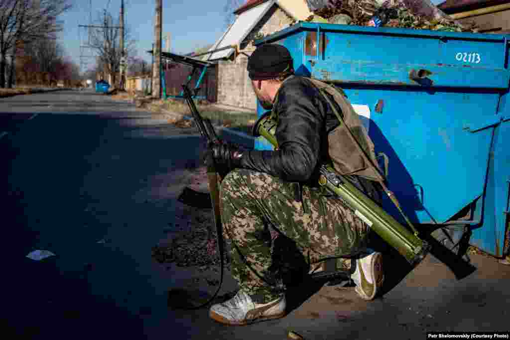 A separatist takes cover in the Kiyevskiy district of Donetsk. The district is&nbsp;close to the airport, which has been the scene of much of the fighting. 