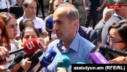 Robert Kocharian talks to journalists after casting his vote in Yerevan on June 20.