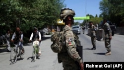Afghan security forces stand guard during the first day of Eid al-Fitr in Kabul on May 24.